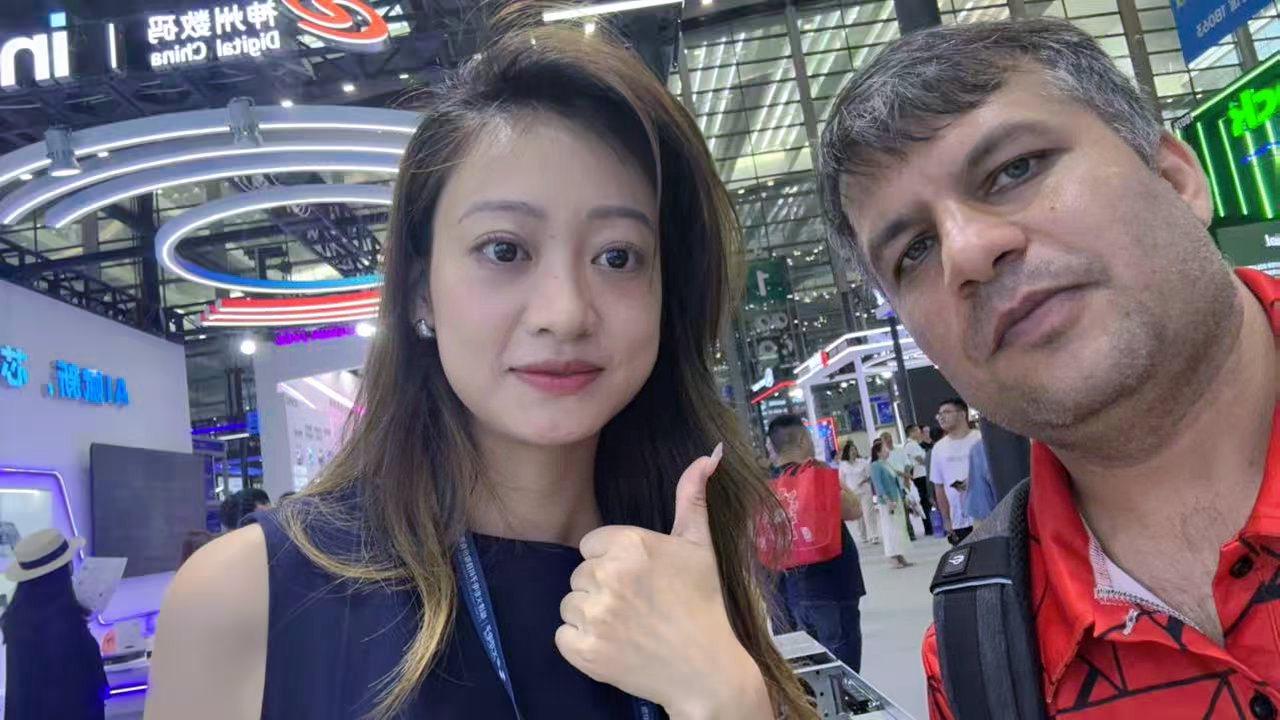 Fan Yang with an international exhibition visitor